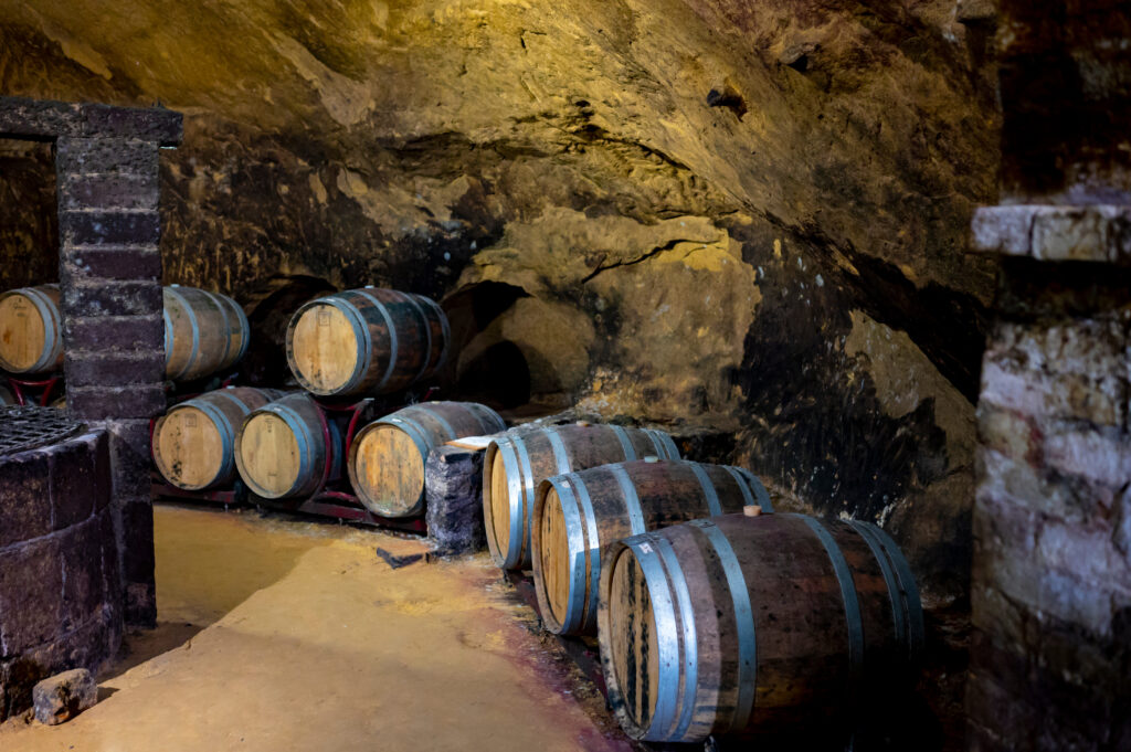 Medieval underground wine cellars with old red wine barrels for aging of vino nobile di Montepulciano in old town Montepulciano in Tuscany, Italy